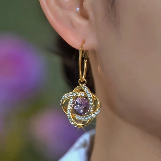 Model showcasing the dangle and style of the 14K Gold-Plated Elegant Purple Zircon Diamond Three-Dimensional Earrings
