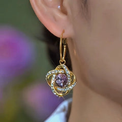 Model showcasing the dangle and style of the 14K Gold-Plated Elegant Purple Zircon Diamond Three-Dimensional Earrings