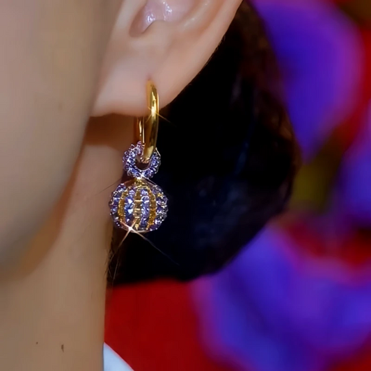 Model showcasing the dangle and style of the 14K Gold-Plated Elegant Purple Zircon Diamoond Earrings
