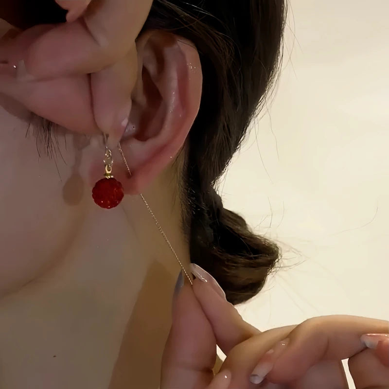 Close-up detail of the sparkling zircons and plating on the Red Crystal Threader Earrings