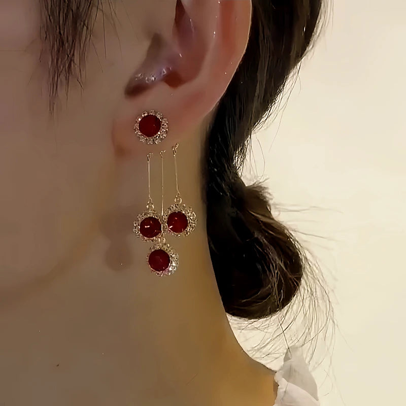 Close-up detail of the sparkling zircons and plating on the Red Crystal Tassel Earrings