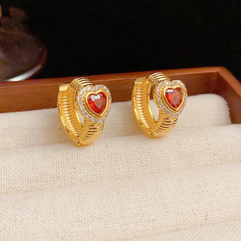 Angled view of the 14K Gold-Plated Elegant Red Heart Hoop Earrings