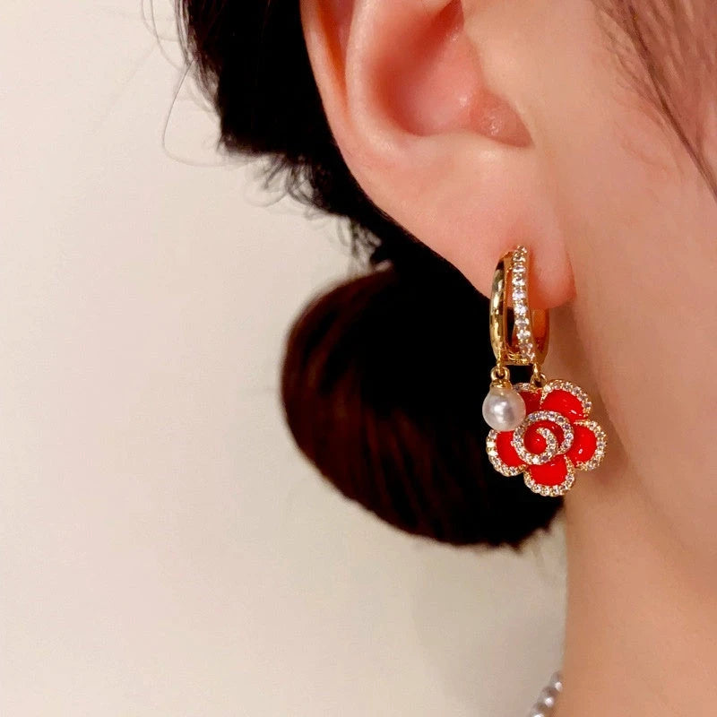 Close-up detail of the sparkling zircons and plating on the Red Flower Pearl Earrings