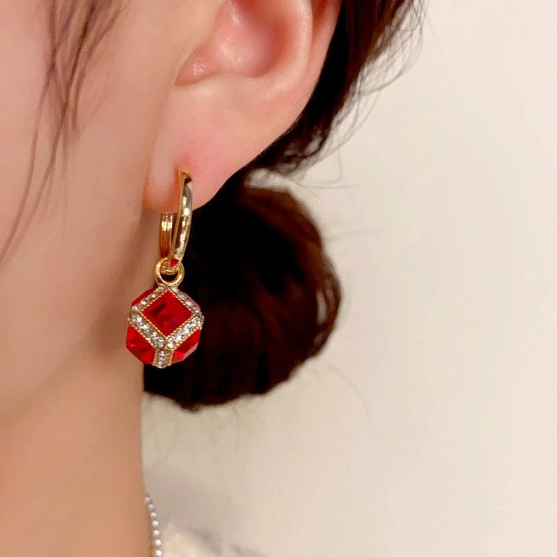 Close-up detail of the sparkling zircons and plating on the Red Zircon Cube Earrings