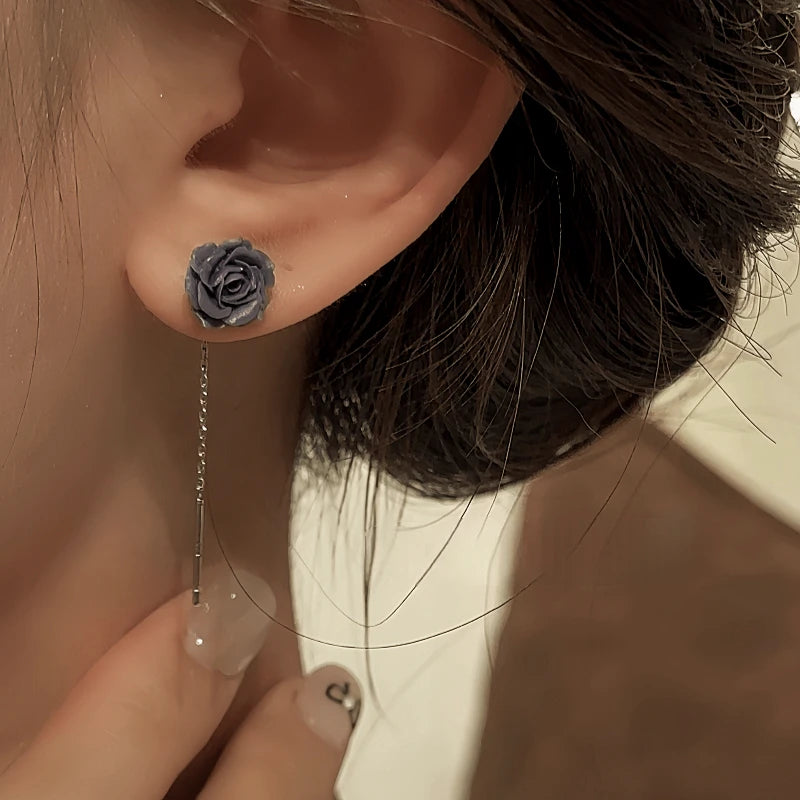 Model showcasing the dangle and style of the 14K Gold-Plated Elegant Resin Black Flower Threader Earrings