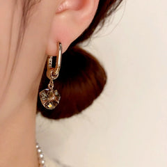 Model showcasing the dangle and style of the 14K Gold-Plated Elegant Rhinestone Ball Earrings