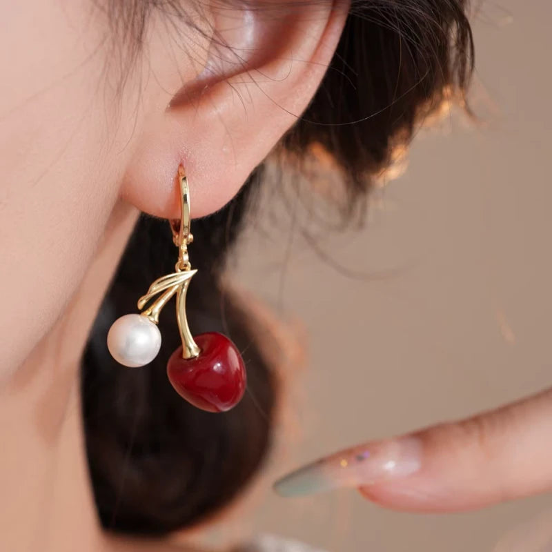 Model showcasing the dangle and style of the 14K Gold-Plated Elegant Rich Style Cherry And Pearl Earrings