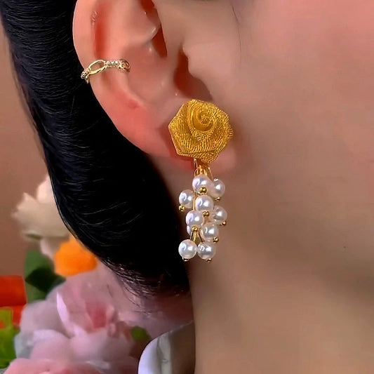 Model showcasing the dangle and style of the 14K Gold-Plated Elegant Rose Bead Tassel Earrings