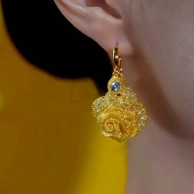 Model showcasing the dangle and style of the 14K Gold-Plated Elegant Rose Flower Tassel Earrings