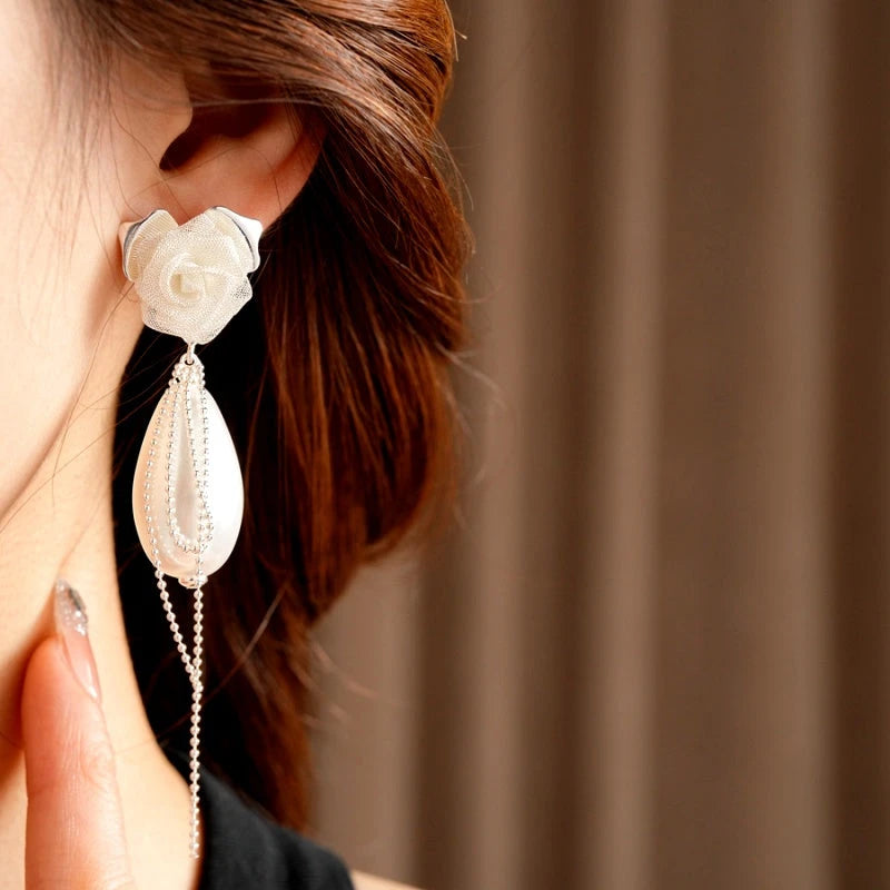 Model showcasing the dangle and style of the 14K Gold-Plated Elegant Rose Pearl Tassel Earrings