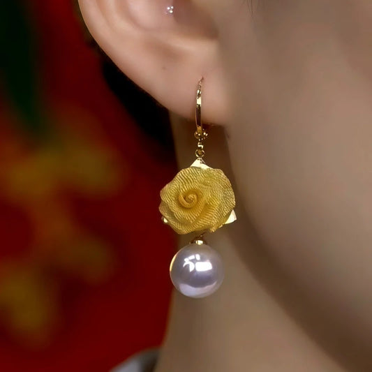 Model showcasing the dangle and style of the 14K Gold-Plated Elegant Rose Pearl Tassel Earrings