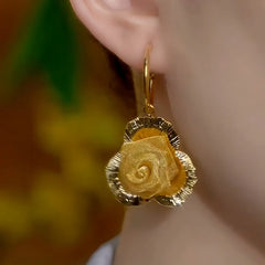 Model showcasing the dangle and style of the 14K Gold-Plated Elegant Rose Pendant Earrings