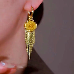 Model showcasing the dangle and style of the 14K Gold-Plated Elegant Rose Tassel Earrings
