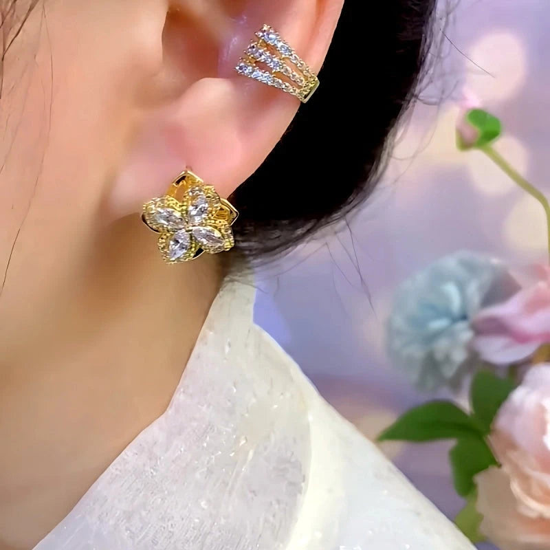 Model showcasing the dangle and style of the 14K Gold-Plated Elegant Rotatable Double-Layer Four-Leaf Flower Stud Earrings