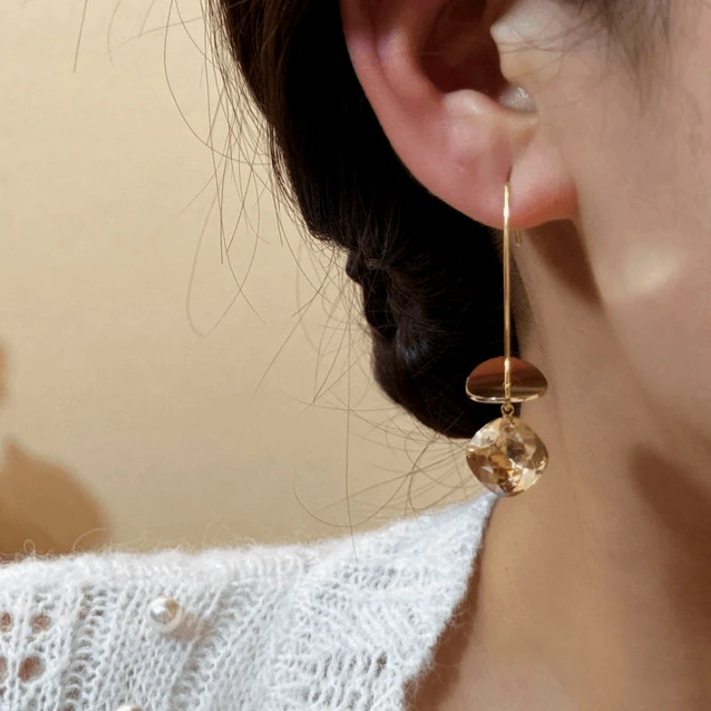 Close-up detail of the sparkling zircons and plating on the Long Threader Earrings