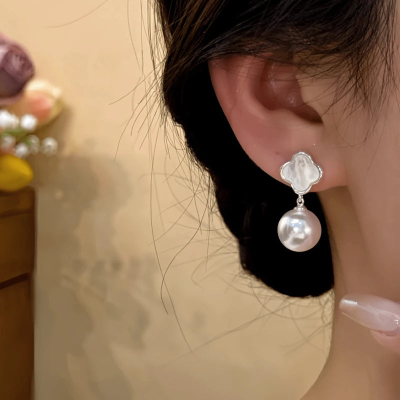 Close-up detail of the sparkling zircons and plating on the Shell Pearl Earrings