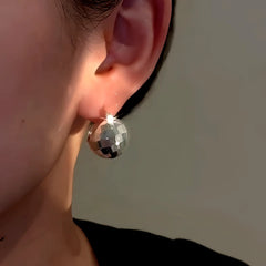 Model showcasing the dangle and style of the 14K Gold-Plated Elegant Silver Basket Earrings