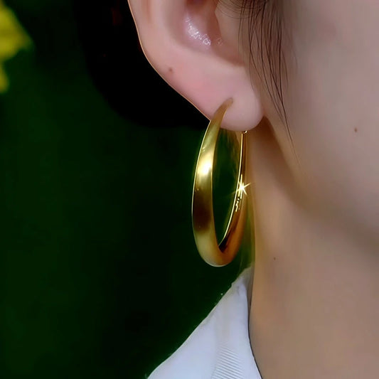 Model showcasing the dangle and style of the 14K Gold-Plated Elegant Simple Big Hoop Earrings