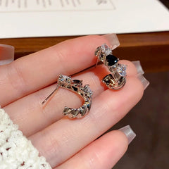 Angled view of the 14K Gold-Plated Elegant Simple Cold Style Zircon Heart Earrings