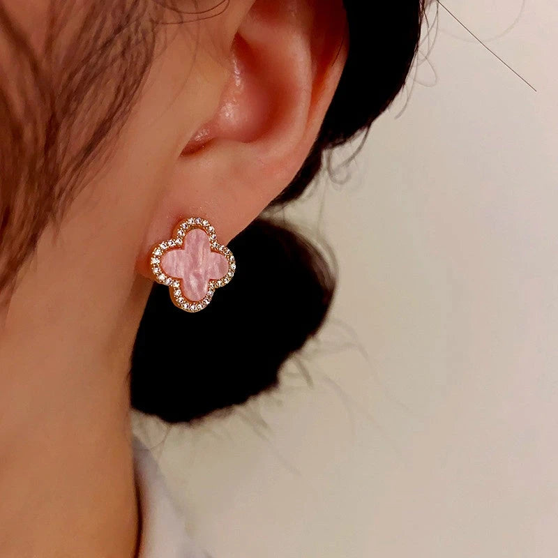 Model showcasing the dangle and style of the 14K Gold-Plated Elegant Simple Flower Stud Earrings