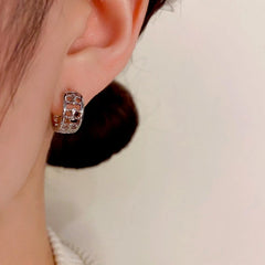 Model showcasing the dangle and style of the 14K Gold-Plated Elegant Small Hoop Earrings