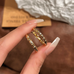 Model showcasing the dangle and style of the 14K Gold-Plated Elegant Snake Bone Hoop Earrings