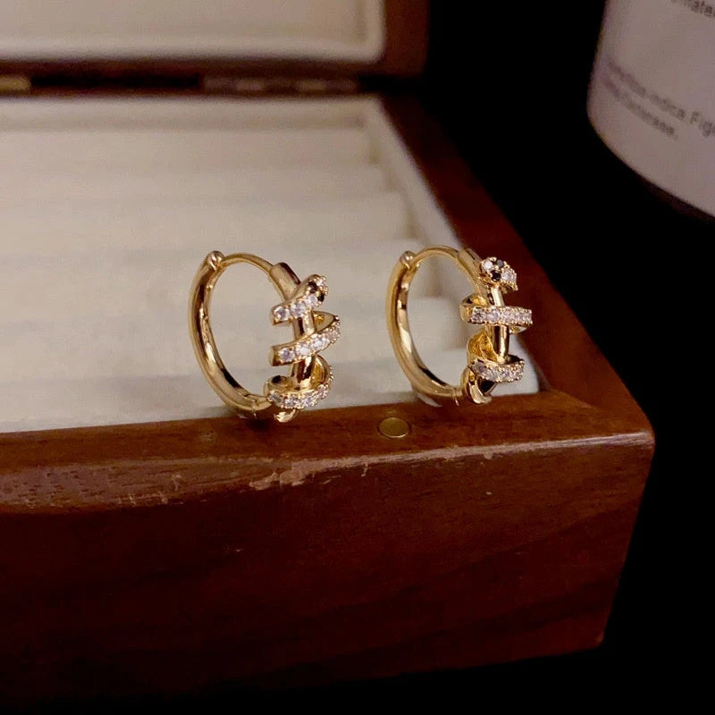 Close-up detail of the sparkling zircons and plating on the Snake Hoop Earrings