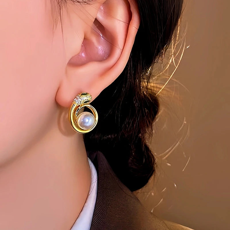 Close-up detail of the sparkling zircons and plating on the Snake Pearl Earrings