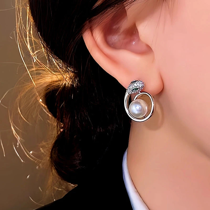 Angled view of the 14K Gold-Plated Elegant Snake Pearl Earrings