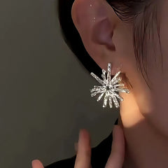 Model showcasing the dangle and style of the 14K Gold-Plated Elegant Snowflake Earrings