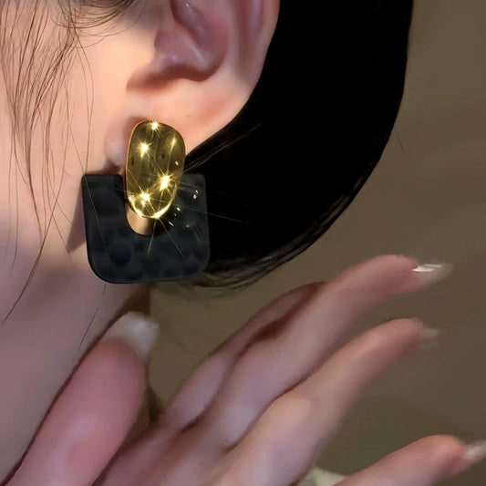 Model showcasing the dangle and style of the 14K Gold-Plated Elegant Square Contrasting Color Earrings