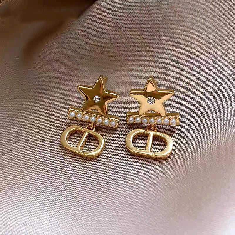 Angled view of the 14K Gold-Plated Elegant Star Pearl Earrings