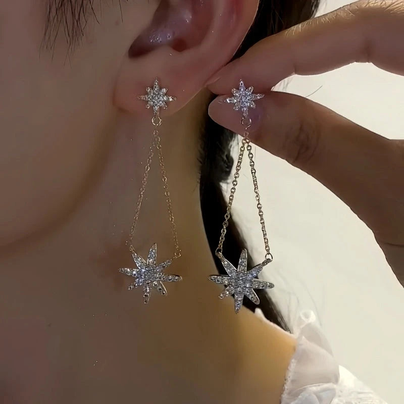 Model showcasing the dangle and style of the 14K Gold-Plated Elegant Star Tassel Earrings