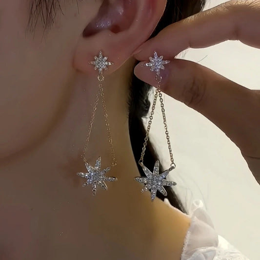 Model showcasing the dangle and style of the 14K Gold-Plated Elegant Star Tassel Earrings