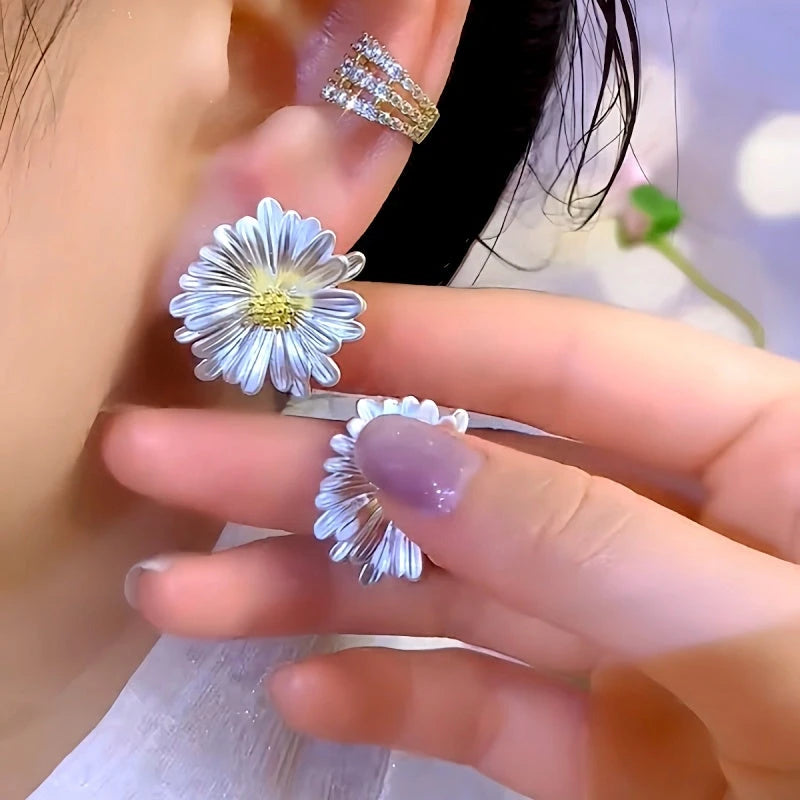 Model showcasing the dangle and style of the 14K Gold-Plated Elegant Sunflower Stud Earrings