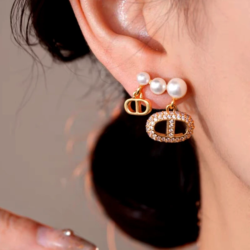 Model showcasing the dangle and style of the 14K Gold-Plated Elegant Sweet Pearl Tassel Earrings
