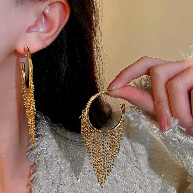 Model showcasing the dangle and style of the 14K Gold-Plated Elegant Tassel Earrings