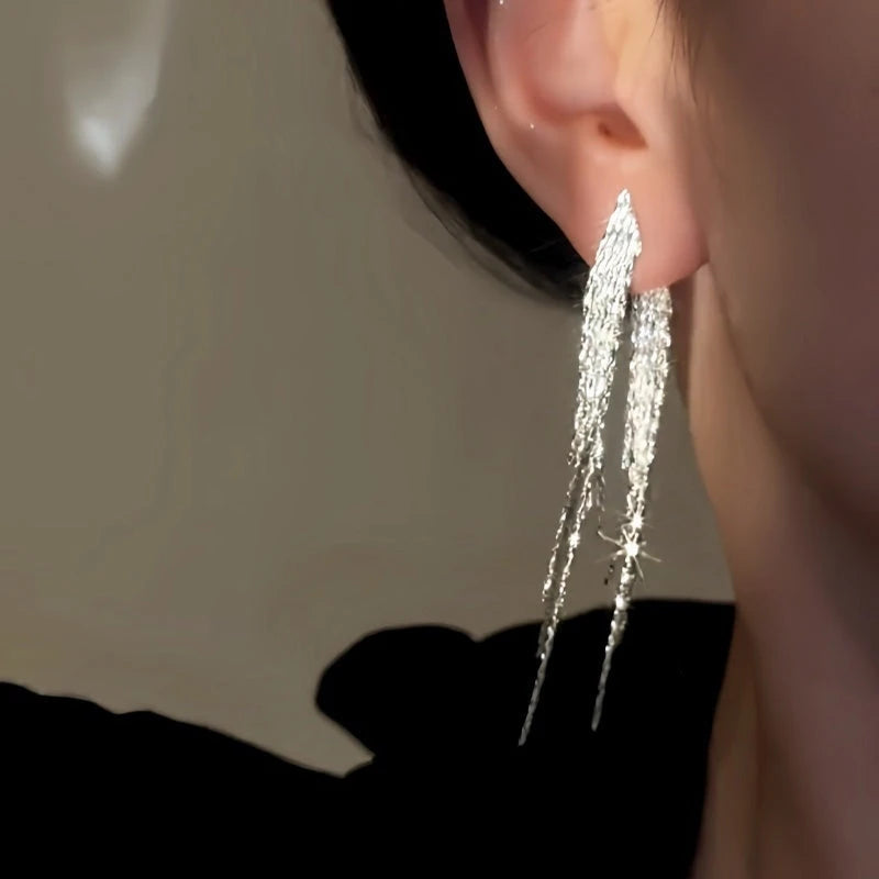 Model showcasing the dangle and style of the 14K Gold-Plated Elegant Tassel Earrings