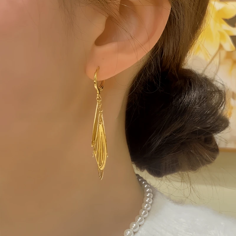 Close-up detail of the sparkling zircons and plating on the Gold Tassel Earrings