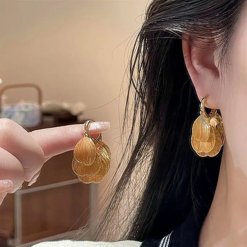 Angled view of the 14K Gold-Plated Elegant Tassel Earrings