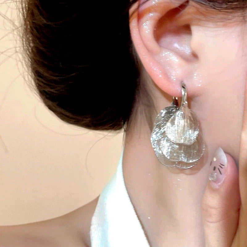 Close-up detail of the sparkling zircons and plating on the Gold Tassel Earrings