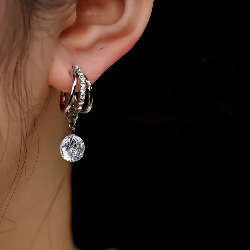 Model showcasing the dangle and style of the 14K Gold-Plated Elegant Three-Dimensional Zircon Water Drop Earrings