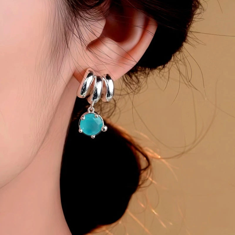 Close-up detail of the sparkling zircons and plating on the Green Zircon Earrings