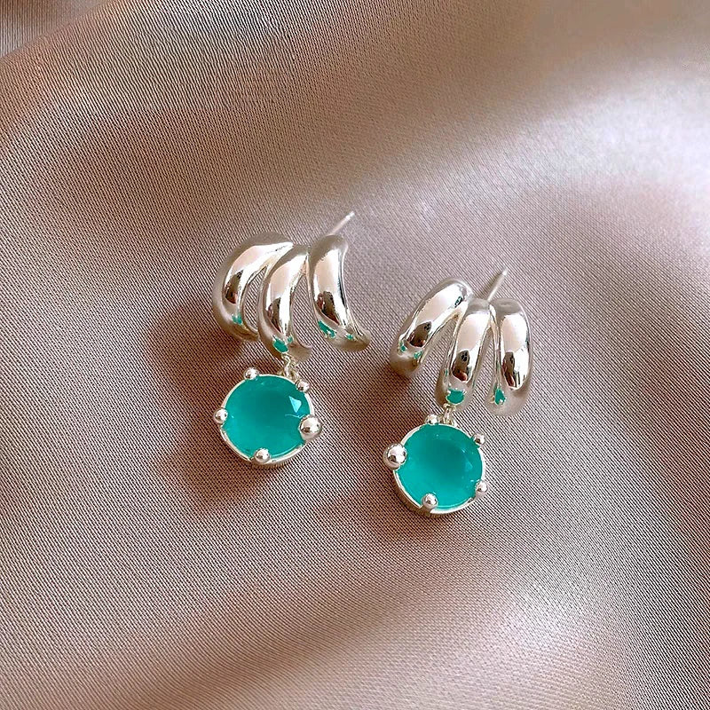 Angled view of the 14K Gold-Plated Elegant Three-Layer Green Zircon Water Drop Earrings