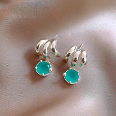 Angled view of the 14K Gold-Plated Elegant Three-Layer Green Zircon Water Drop Earrings