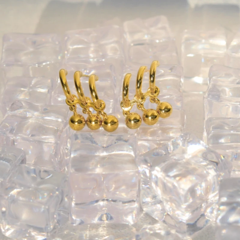 Angled view of the 14K Gold-Plated Elegant Three-Layer Water Drop Earrings