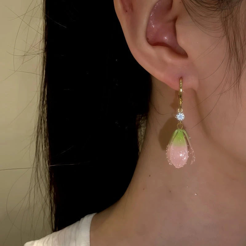 Model showcasing the dangle and style of the 14K Gold-Plated Elegant Tulip Flower Earrings