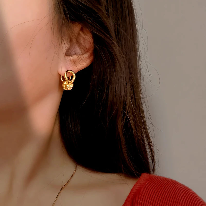 Close-up detail of the sparkling zircons and plating on the Knotted Dangle Earrings