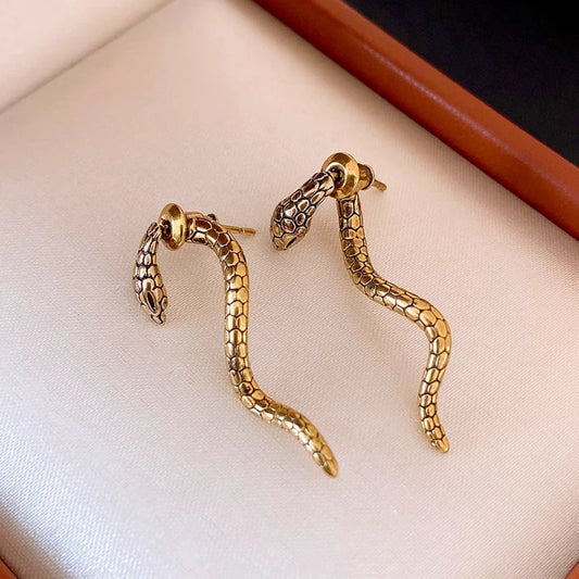 Model showcasing the dangle and style of the 14K Gold-Plated Elegant Twisted Snake Earrings