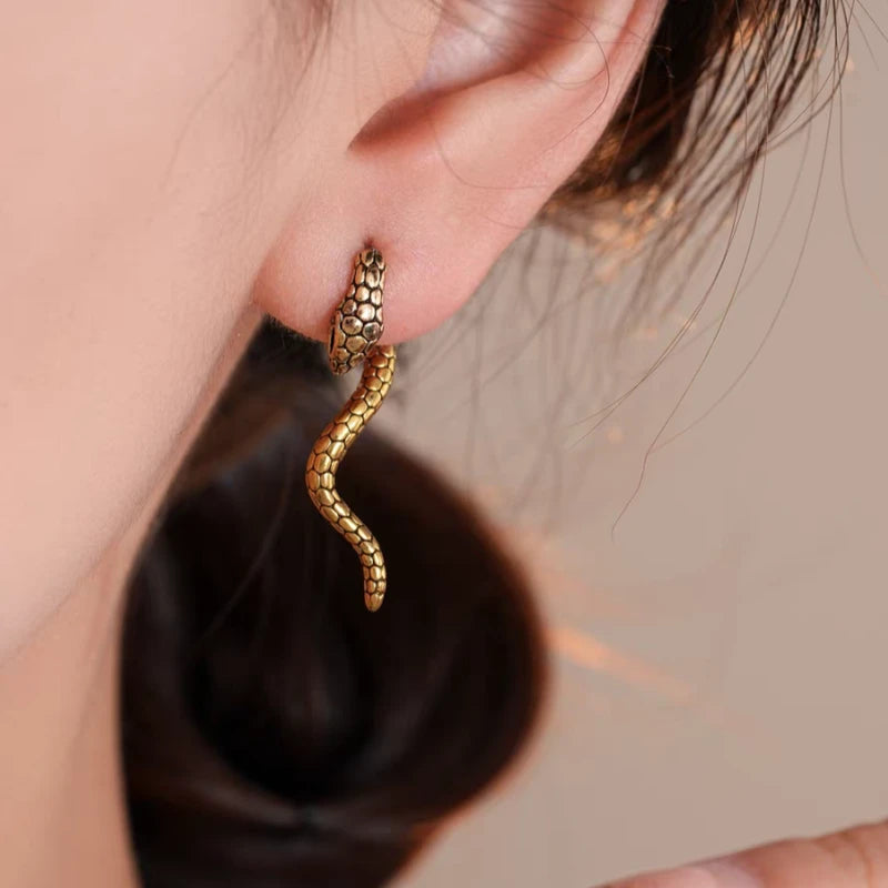 Close-up detail of the sparkling zircons and plating on the Snake Jacket Earrings
